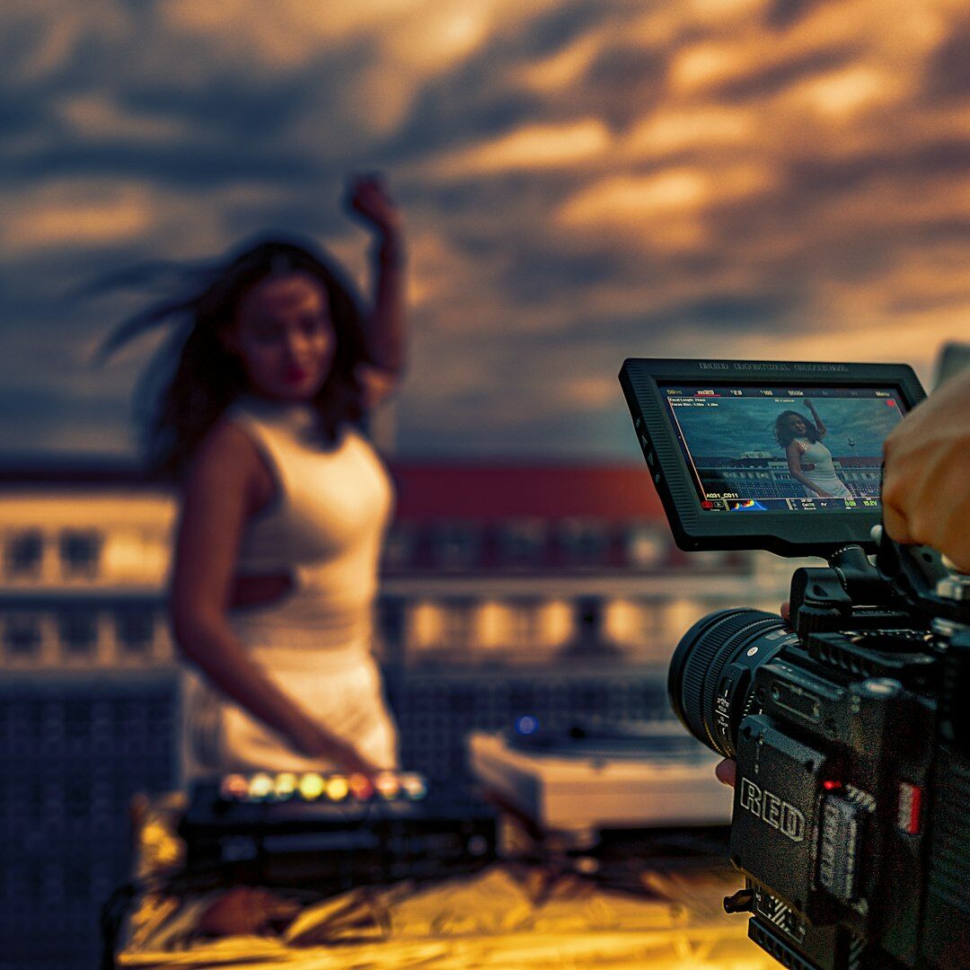 Camera operator adjusting a broadcast camera on set